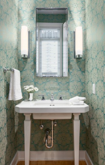 beautiful renovated powder room with green floral wallpaper